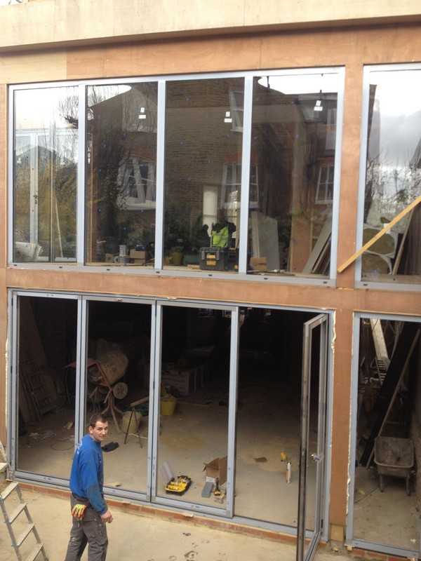 Aluminium bi-fold doors with two-storey glazing in Wokingham