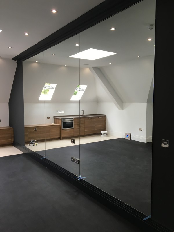 Frameless glass partition in loft conversion by Wokingham glaziers