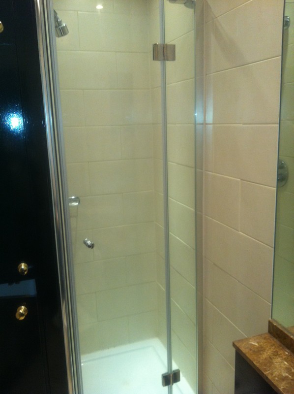 Frameless glass shower enclosure with chrome fittings in Wokingham